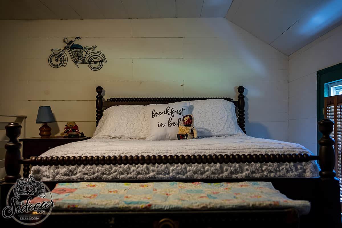 Corkscrew Suite bedroom with motorcycle wall art