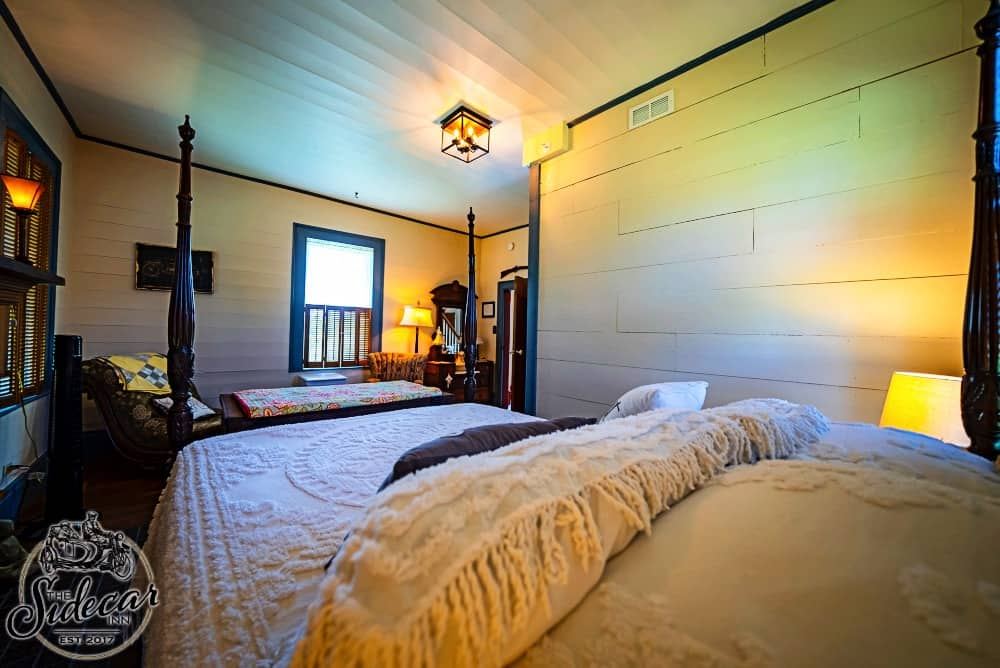 Laconia Bedroom bed with Sidecar Inn branding